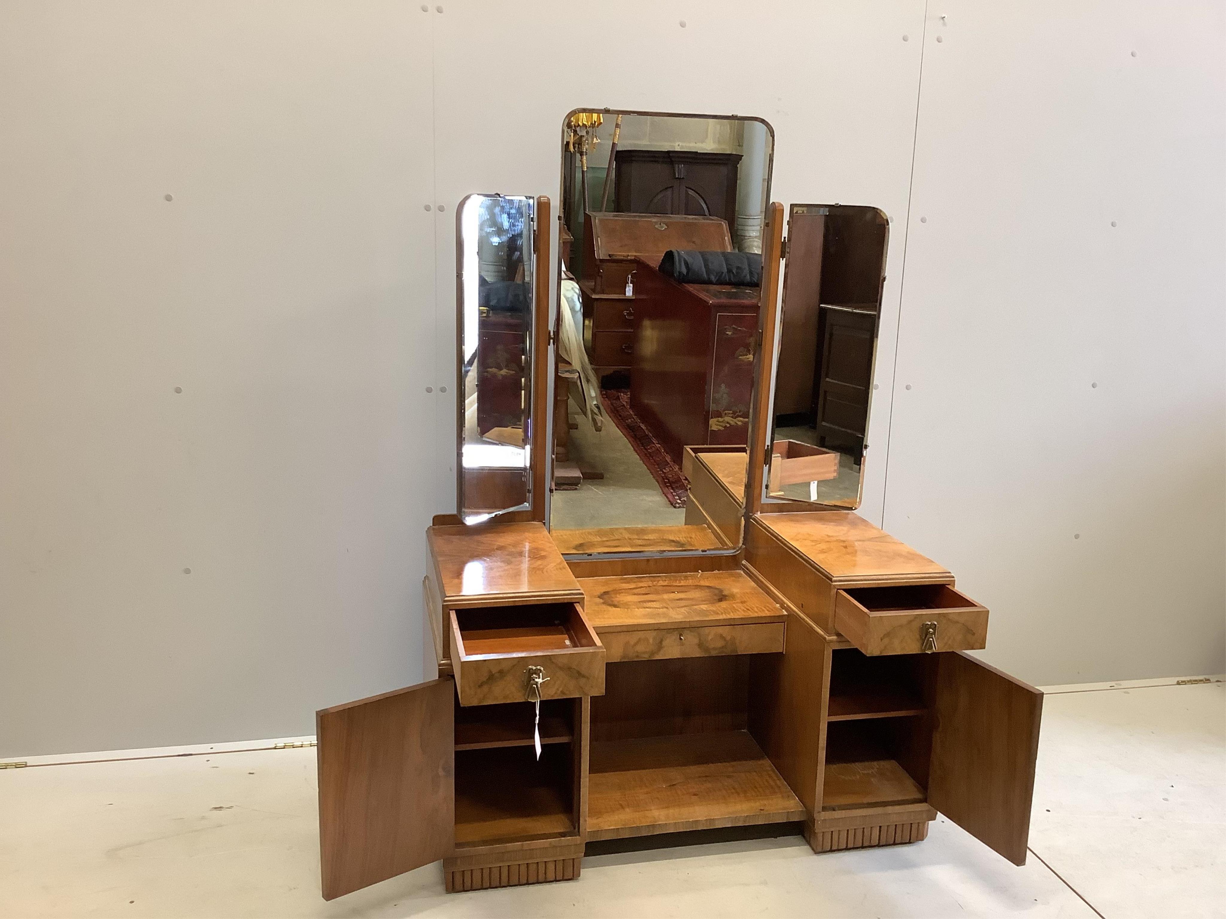 An Art Deco walnut dressing table, width 107cm, height 154cm. Condition - fair to good